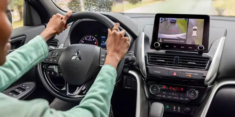an interior shot of a woman driving a 2025 Mitsubishi Eclipse Cross