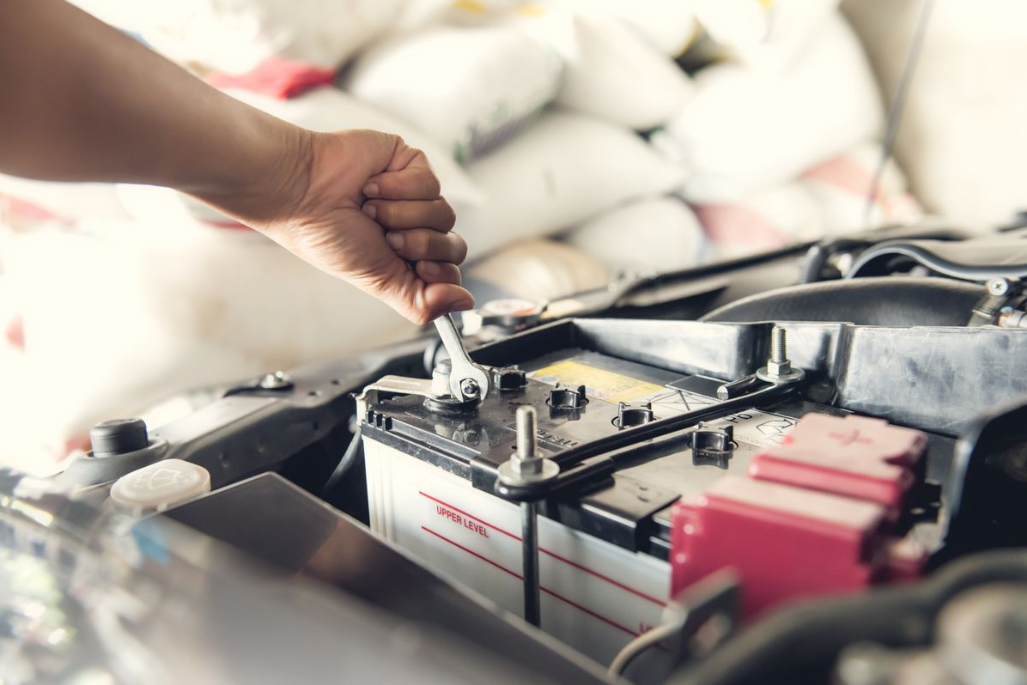 a mechanic working on a car battery